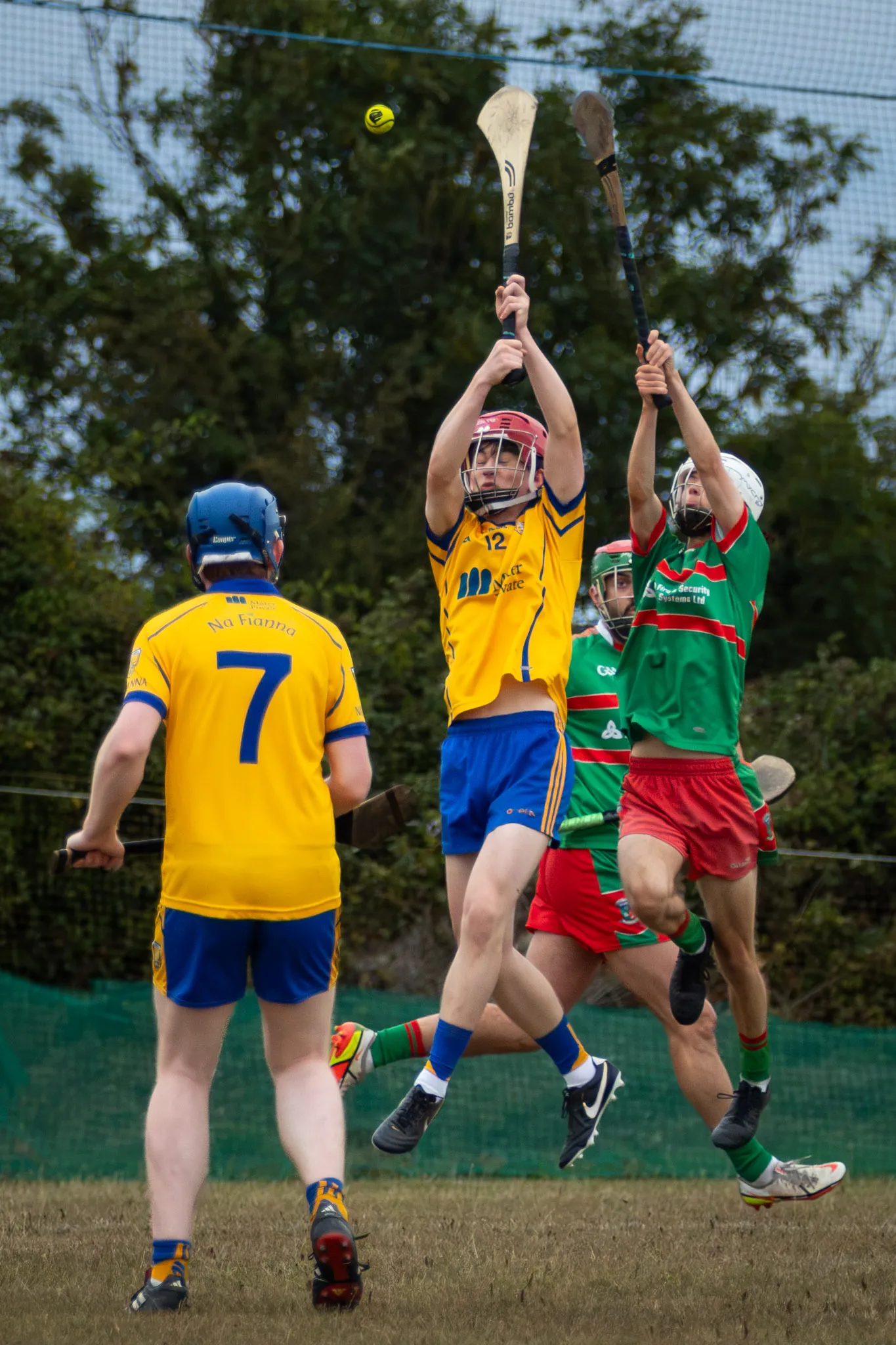 A Na Fianna hurler and a Naomh Barróg defender rise together to contest a dropping sliotar at Collinstown.