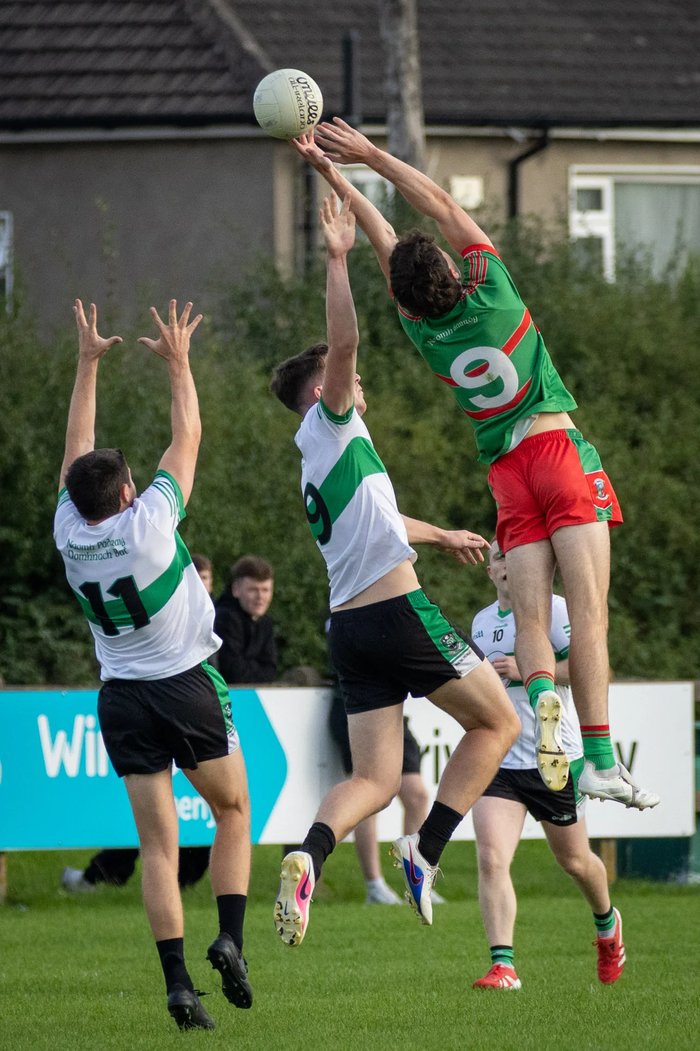 Naomh Barróg's number 9 climbs above two St Patrick's Donabate players to catch a high ball at Pairc Barróg.